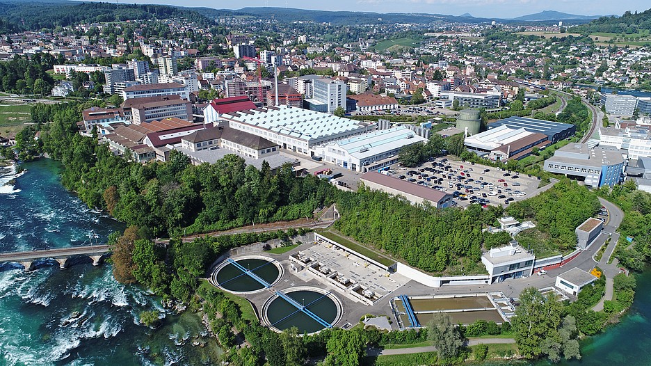 Weite Teile der Gemeinde Neuhausen werden mit Abwärme aus der Abwasserreinigungsanlage Röti (im Vordergrund), die im Kesselhaus auf dem Industriegebiet (im Hintergrund) erhitzt wird, versorgt.